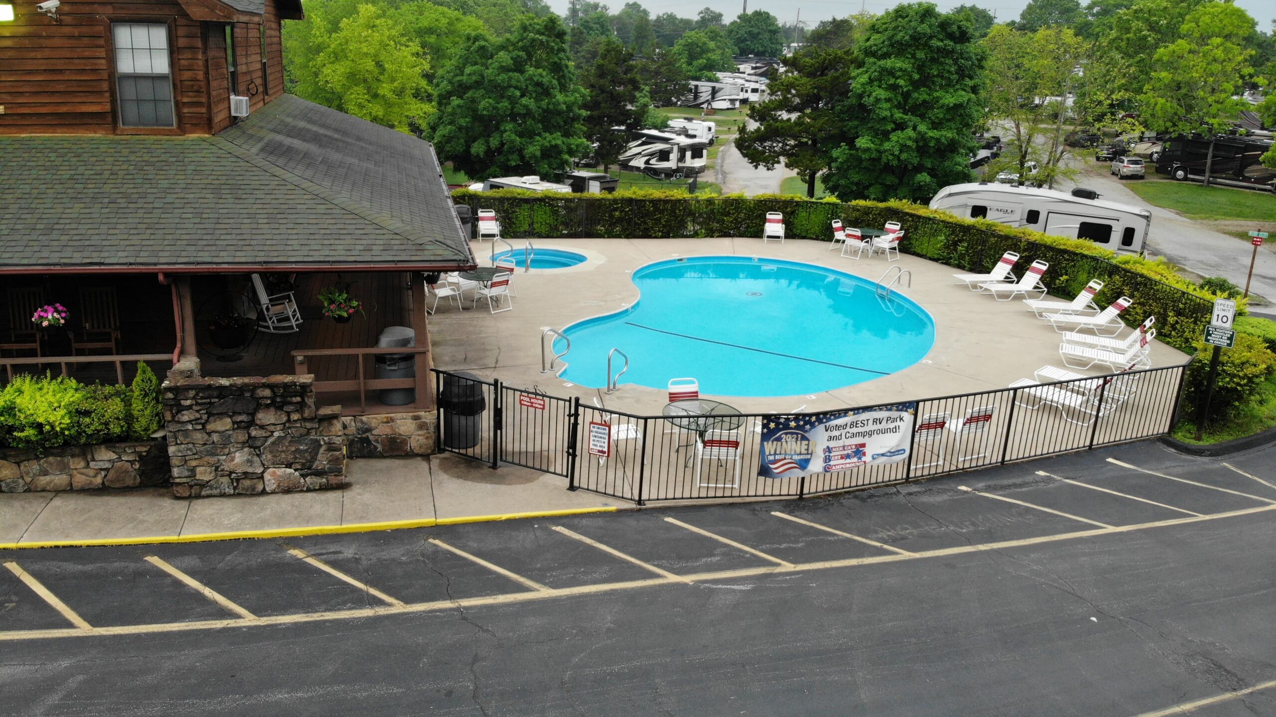 A black metal fence surrounds a swimming pool
