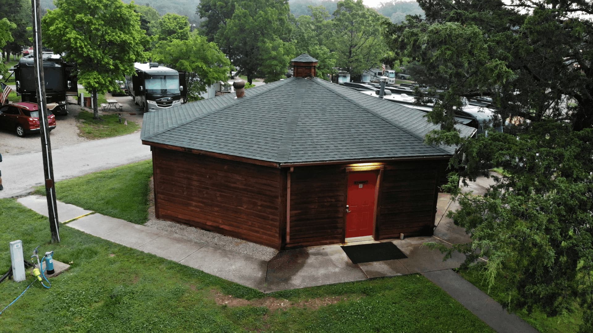 A small wooden cabin with a red door